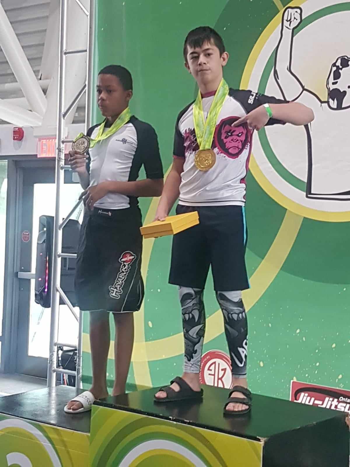 Two young Silverback athletes on the podium with their medals